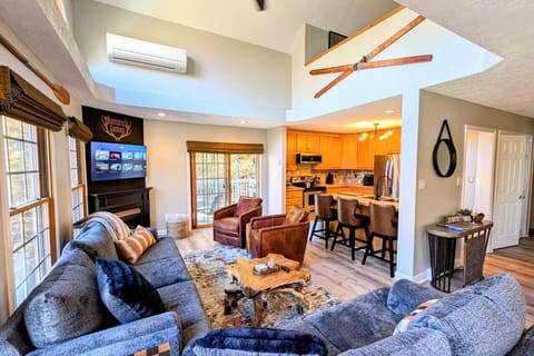 Living room with ample seating with gas fireplace and large smart TV