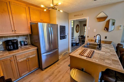 Fully stocked kitchen including crock pot, Keurig and coffee pot stocked with coffee pods, sugar, and creamer