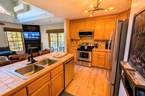 Fully stocked kitchen including crock pot, Keurig and coffee pot stocked with coffee pods, sugar, and creamer