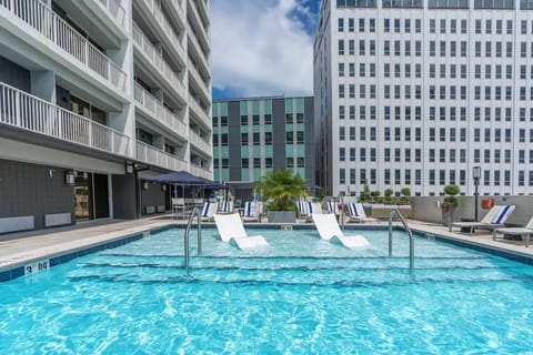 Float and relax with in-water loungers and open sky.