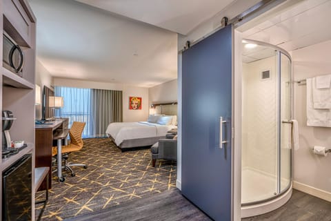 Unwind in a bright room with plush bedding and workspace.