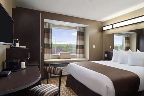 Unwind in crisp linens beside a bright window nook.