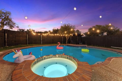 Enjoy breathtaking Texas sunsets by the sparkling swimming pool, surrounded by vibrant orange skies.