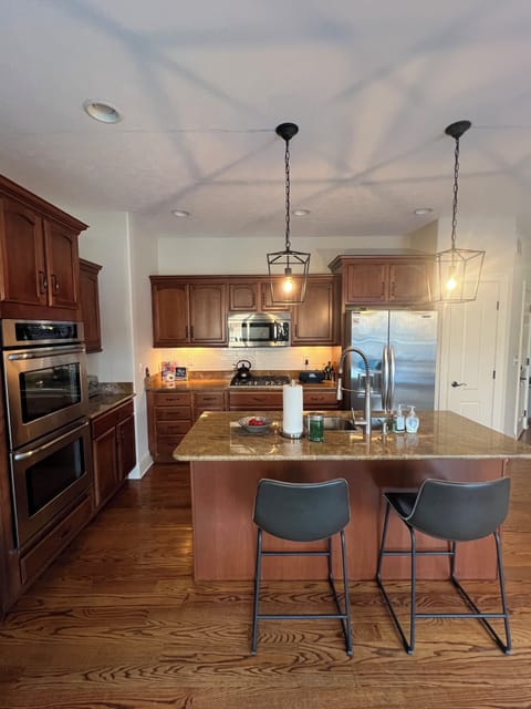 Kitchen with double oven, range, pantry and plenty of cookware.