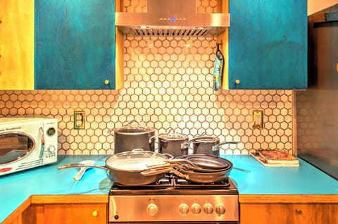 A variety of pots and pans as well as plenty of cooking knives & utensils.