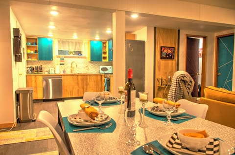 Open concept living, dining and kitchen area with dimmable lights.