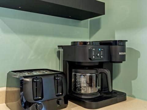 Modern coffee machine and toaster located on the kitchen counter.