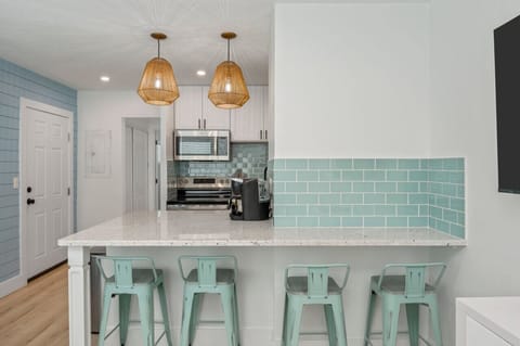 Chic chairs and a modern countertop create a perfect gathering spot.