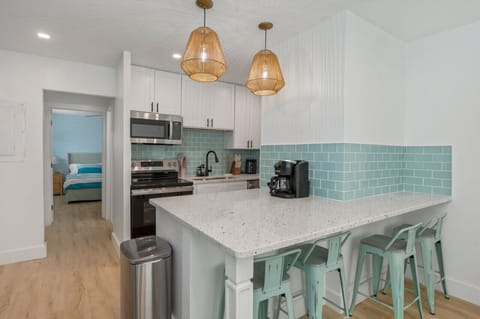 Bright and functional kitchen with a convenient door leading directly to the bedroom for seamless living.