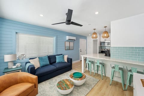 Cozy living room with a comfy sofa bed, perfect for relaxing with a sneak peek of the modern kitchen just beyond. A space that blends comfort and convenience!