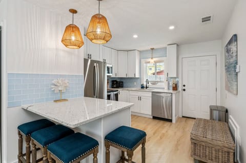 Chic chairs and a modern countertop create a perfect gathering spot.