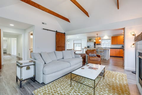 Living room with a plush couch and comfy chair. Right next to the kitchen to keep the conversations flowing.