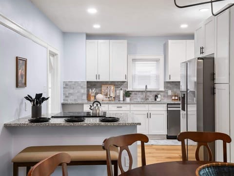 Our sophisticated dining area, adjacent to a modern kitchen, offers the perfect setting for memorable dining experiences