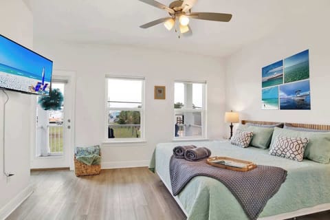 Has a cozy King bed with a 55" smart TV, an ensuite bathroom, a work desk, and a balcony with bay views. It also features a sound machine for a good night sleep and ample closet space for your convenience.