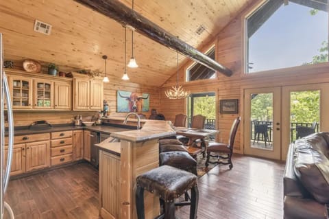 Open concept kitchen/dinning area with large windows facing the lake