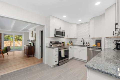 Our newly renovated kitchen opens directly into the living area and sunroom, creating a spacious, airy atmosphere for your group to gather and relax.