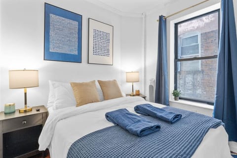 Calming blue toned bedroom, with wide windows and natural light