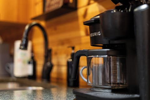 Start your mornings right with fresh coffee in our cozy cabin kitchen!