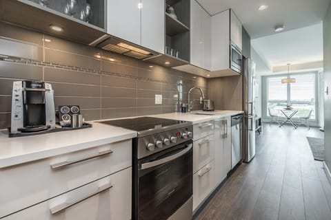 Sleek modern kitchen with stainless steel appliances and bright natural light
