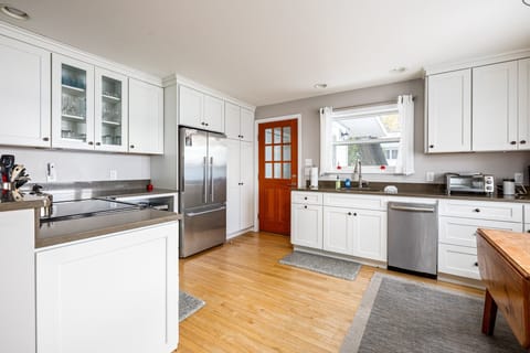 The modern appliances and ample counter space make cooking a pleasure. This includes a refrigerator, stove, and dishwasher.