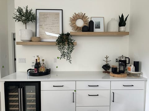 The wine fridge and coffee bar create the perfect beginning and end to each day