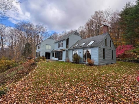 Outside view looking north west. Living room on right. Dining in middle. Game room on left. Master bedroom on left 2nd level above the game room. Room 2 in middle 2nd level above the dining.