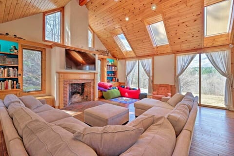 Sun filled living room with vaulted ceiling and great view of Mt Equinox. Bean bags, TV, books, games. Large sectional sofa that can accommodate large group. Floor heating and AC. There is a shower and sink which can be used by guests in bedroom 3.