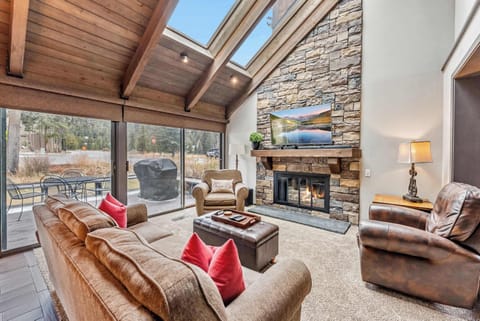Living Room: Couch, 2 chairs, 55” TV w/cable, sound bar, gas fireplace, vaulted ceilings, skylights, open layout