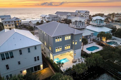 Coastal vacation rental community with beachfront properties and private pools, showcasing elevated homes with ocean access.