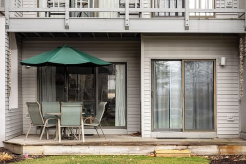 Private patio w/ outdoor dining set & umbrella, perfect for relaxing in the fresh air.
