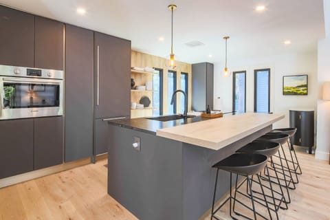 The modern kitchen features top of the line electric appliances.