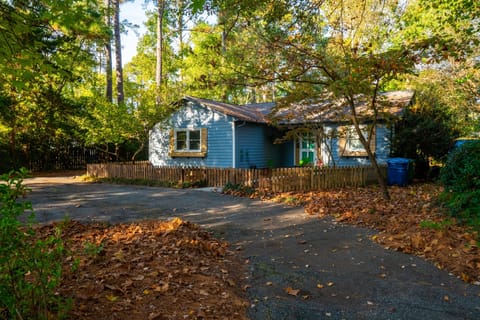 Front of home after windy, fall day. Old growth trees and circle driveway.