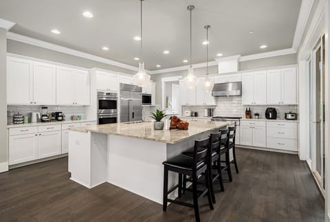 Prepare delicious meals in this state-of-the-art kitchen, fully equipped with modern appliances and thoughtfully designed for both style and functionality. Perfect for culinary adventures or casual family dinners!