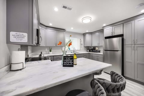 The breakfast bar adds a cozy touch, perfect for casual dining or enjoying a morning coffee.