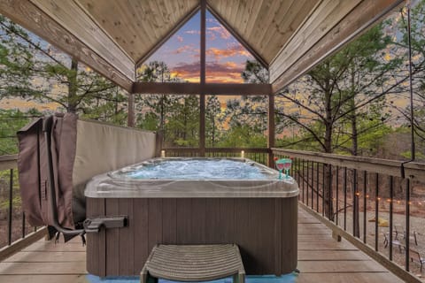 Unwind in the bubbling hot tub, surrounded by peaceful forest views. A perfect spot for relaxation and nature’s tranquility.