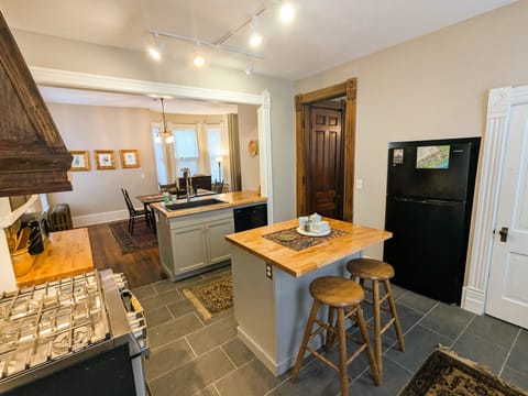 KITCHEN - gas stove, custom range hood, recessed refrigerator, 2 islands