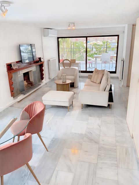 Bright and cozy living room with a fireplace and balcony access.
