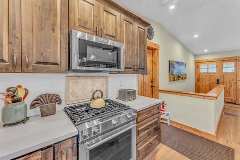 Kitchen: New KitchenAid appliances, drip coffee maker, waffle maker, kitchen island with 3 barstools 
