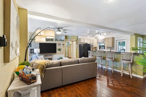 Sink into the plush sofa and enjoy the seamless flow from the living area to the kitchen