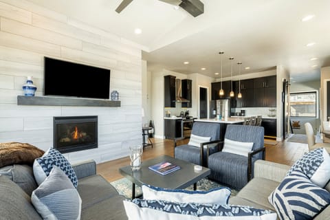 Living Room with Balcony, Fireplace, TV, & Skiing Views