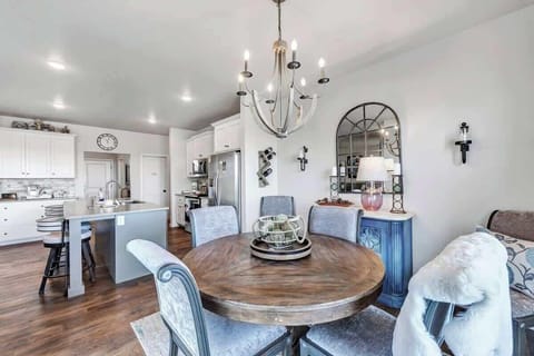 Fully equipped kitchen with pots/pans, utensils, place setting for 5 to 6 people, and modern appliances