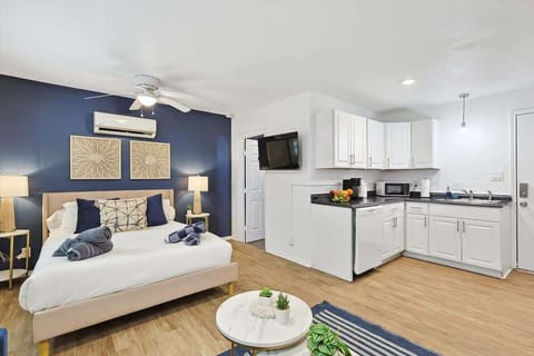 Unwind in this beautifully designed primary suite, featuring a plush queen bed, modern decor, and a convenient kitchenette