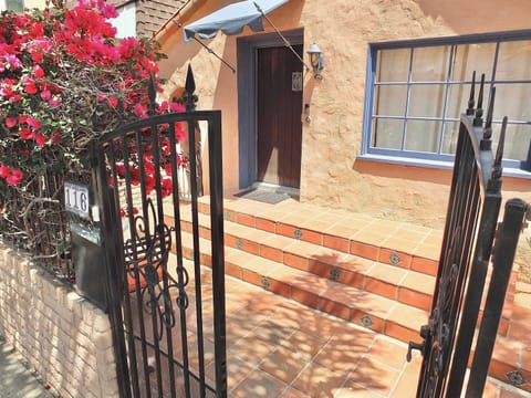 Enjoy your getaway relaxing by lush vining flowers in the front garden