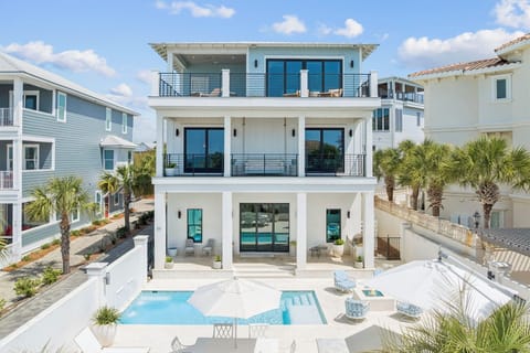 Modern beachside villa featuring multiple levels of luxury with private pool and tropical landscaping in an upscale coastal neighborhood.