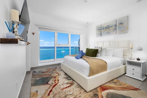 Wake up to breathtaking sea views from your plush bed, with a sailboat drifting by and the sparkling azure waters framing your perfect coastal escape.