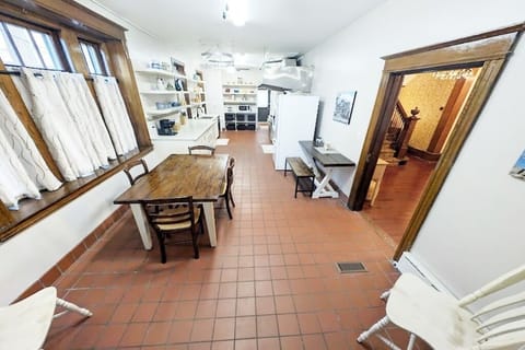 A well-lit, fully-equipped kitchen with a stove, fridge, and cooking needs!