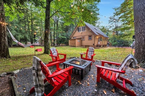 Backyard Fire Pit with Adirondack Chairs in the Woods