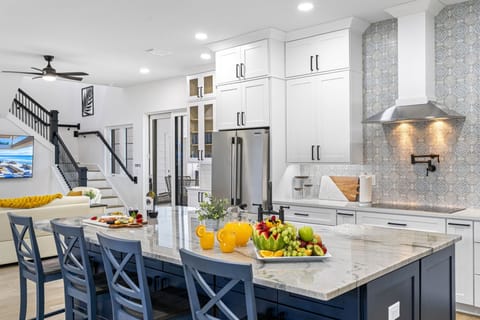 The kitchen is fully equipped with the latest appliances, including a refrigerator, stove, oven, microwave, and dishwasher.