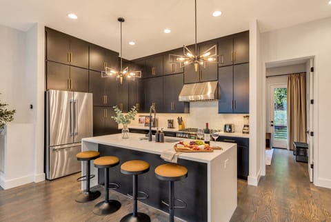 Step into luxury with this sleek kitchen featuring modern appliances and stylish seating—perfect for gathering with friends or family. Experience the best of Nashville with Misfit Homes. Reserve your stay today and make memories in Music City!