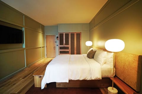 Unwind in a spacious bedroom with warm, calming lighting.